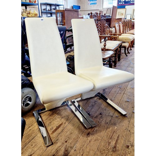 344 - Pair of retro style dining chairs in cream leatherette and chrome