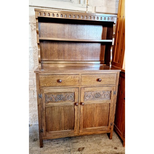 378 - Mid century small oak dresser with open plate rack over two drawers and a cupboard