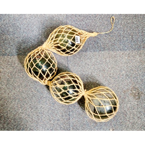 403 - Four green glass floats in string net