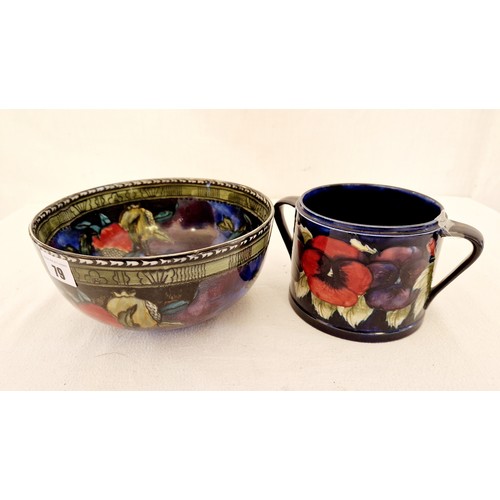 79 - Two pieces of decorative pottery - a Moorcroft Pansy two handled jar (damaged) and a Rubensware pome... 
