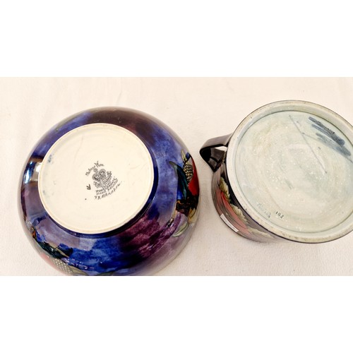 79 - Two pieces of decorative pottery - a Moorcroft Pansy two handled jar (damaged) and a Rubensware pome... 
