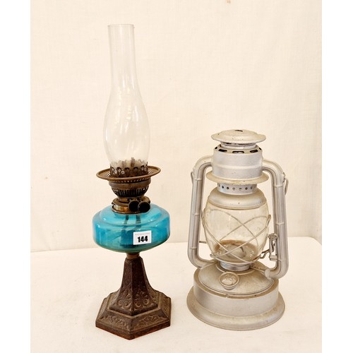 144 - Edwardian oil lamp with glass reservoir on cast metal base and modern Tilley lamp