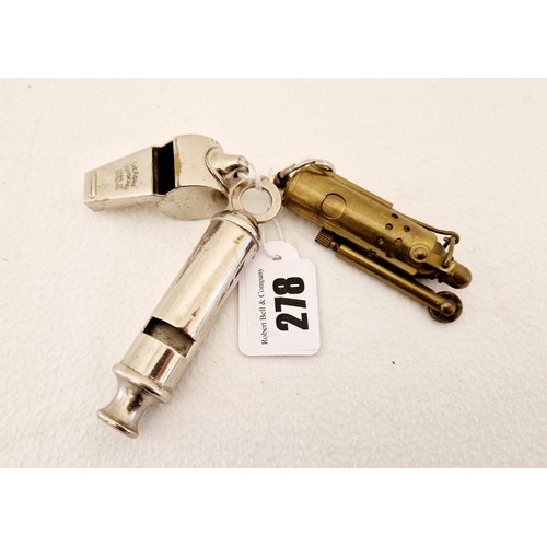 278 - Two vintage Acme whistles, The Thunderer and the Scoutmaster and a brass cigarette lighter