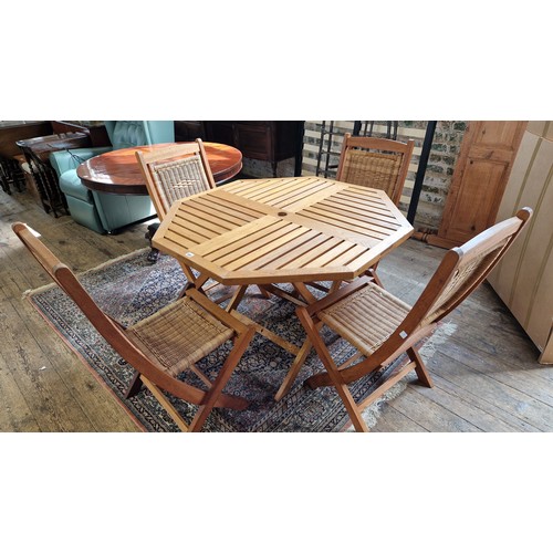 393 - Wooden garden furniture set comprising folding octagonal table and four faux raffia folding chairs