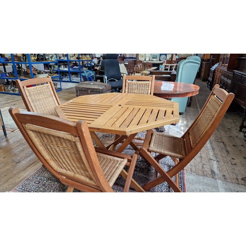 393 - Wooden garden furniture set comprising folding octagonal table and four faux raffia folding chairs