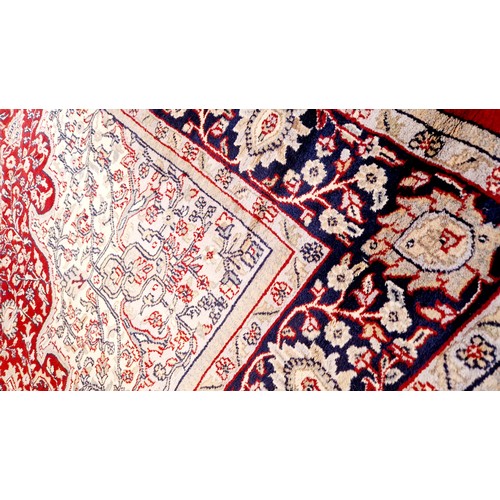 317 - Large red and blue floral patterned woollen rug, 126