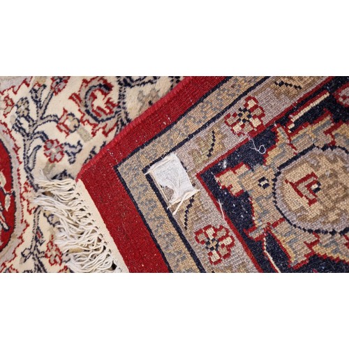 317 - Large red and blue floral patterned woollen rug, 126