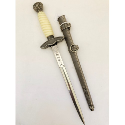 219 - A Third Reich WWII reproduction dress dagger, with white celluloid grip and scabbard