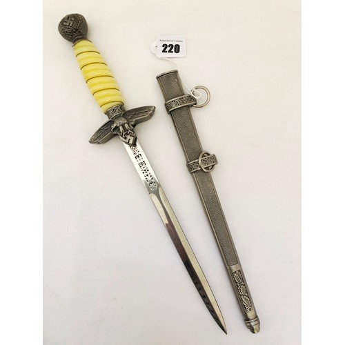 220 - A Third Reich WWII reproduction dress dagger, with white celluloid grip with grip wire and scabbard