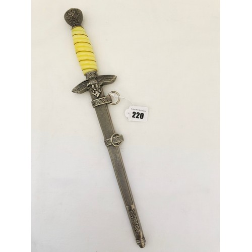 220 - A Third Reich WWII reproduction dress dagger, with white celluloid grip with grip wire and scabbard