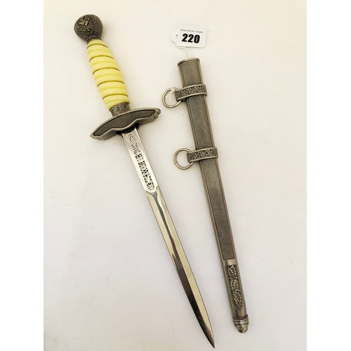 220 - A Third Reich WWII reproduction dress dagger, with white celluloid grip with grip wire and scabbard