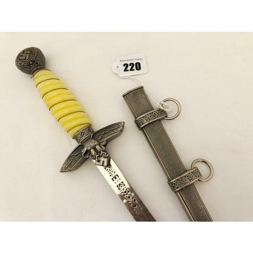 220 - A Third Reich WWII reproduction dress dagger, with white celluloid grip with grip wire and scabbard