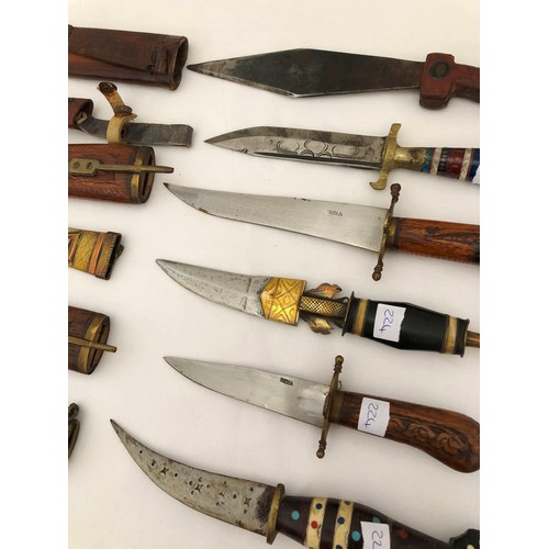 224 - A group of six eastern and Indian daggers with carved wooden brass & leather sheaths