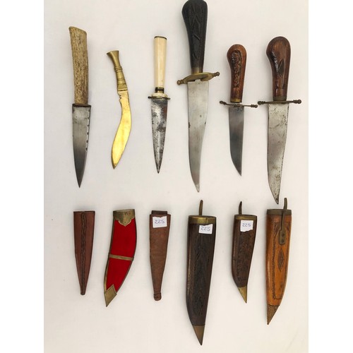 225 - A group of six eastern and Indian daggers, one reproduction, with carved wooden and leather sheaths