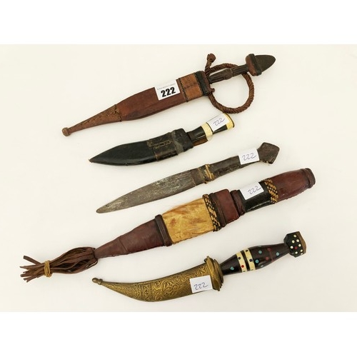 222 - A group of five 19th century eastern & Indian daggers, including leather and ornamental brass sheath... 