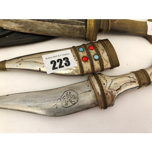 223 - A group of five eastern and Indian daggers, including ornamental jewelled and embroidered sheaths