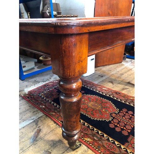 298 - Late 19th century mahogany rectangular wind out dining table on turned legs and brass castors, one s... 