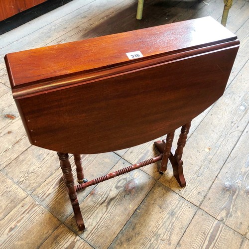 316 - Reproduction mahogany Sutherland table on turned supports