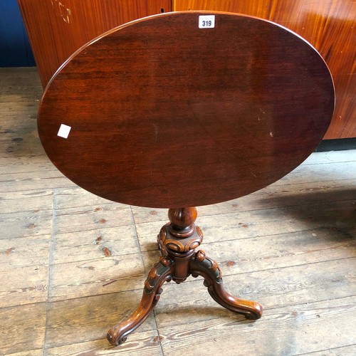 319 - Reproduction mahogany oval tilt top occasional table on decorative carved support