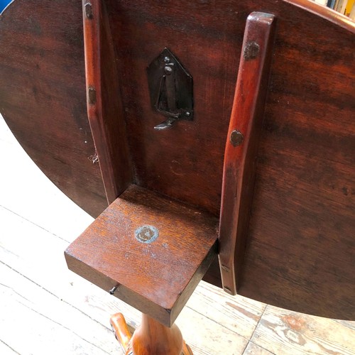 319 - Reproduction mahogany oval tilt top occasional table on decorative carved support