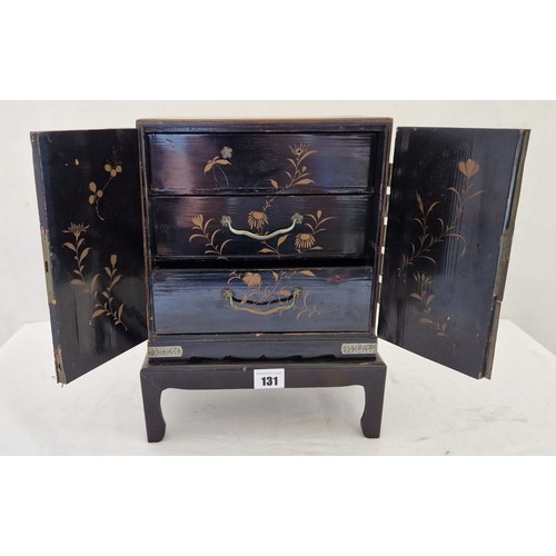 131 - Lacquered oriental style jewellery box with relief panels of birds and flowers and fitted interior