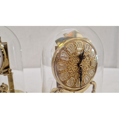 166 - Two glass domed clockwork mantel clocks