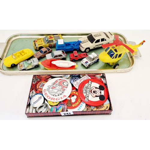 241 - Various play worn loose toy vehicles and tin of children's badges