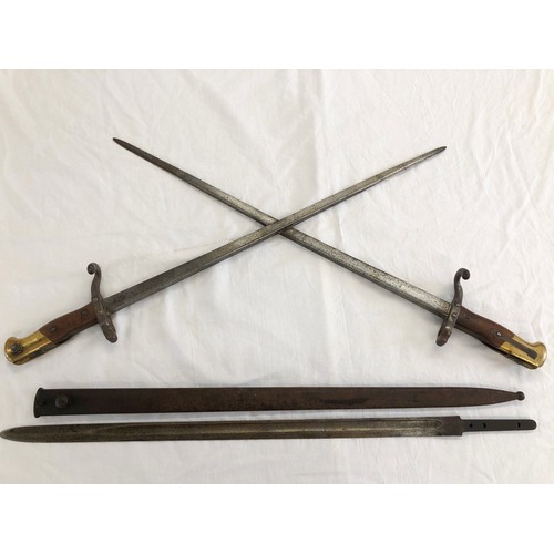 164 - Two French Model 1874 Gras bayonets, fused to form a cross, the cross pieces adapted to become hooks... 