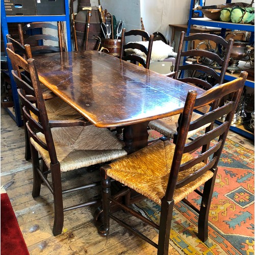 302 - Mid century oak dining suite comprising refectory style table and set of 6 (4+2) ladder back rush se... 