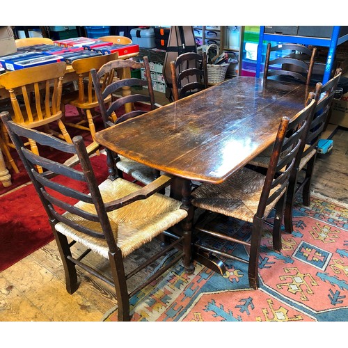 302 - Mid century oak dining suite comprising refectory style table and set of 6 (4+2) ladder back rush se... 