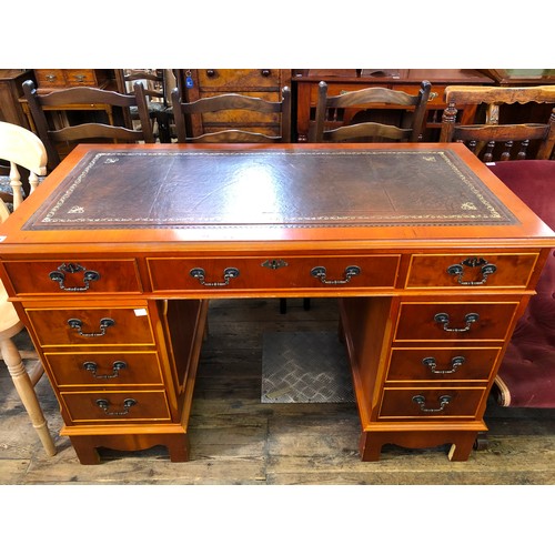 323 - Reproduction yew pedestal desk with tooled leatherette top