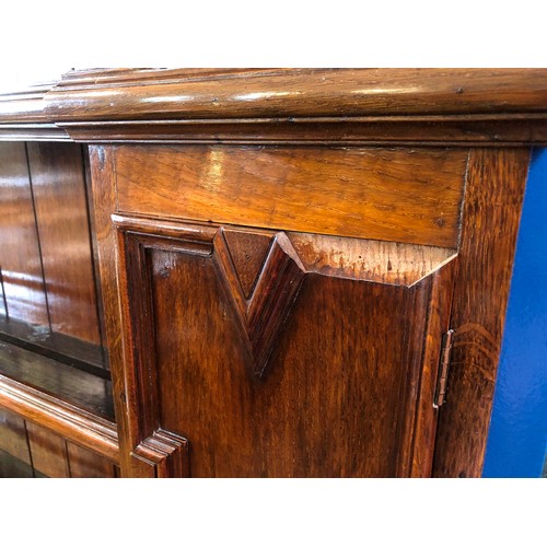 366 - Mid century oak dresser with plate rack and cupboards over a base of drawers and cupboards, geometri... 