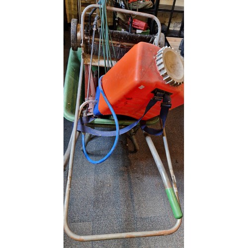 389 - Garden accessories incl wheelbarrow, leaf sweeper, knap sack sprayer and fencing stakes