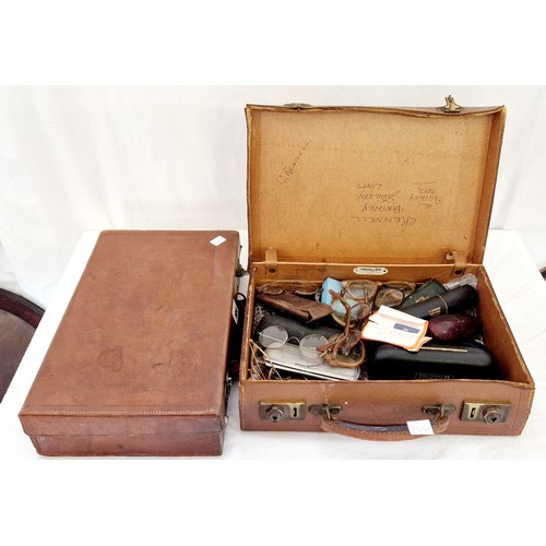 104 - Two small leather box cases, one containing a quantity of cased and loose wire rimmed spectacles etc