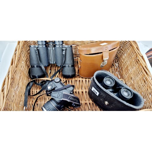 134 - Wicker hamper containing three pairs of binoculars, Halina 8x30, no lens caps; Prinz 10x50 no case o... 