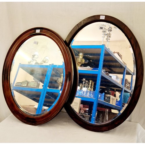 297 - Two mid century mahogany framed oval wall mirrors