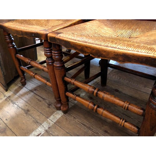 335 - Pair of oak framed spindle back rush seated kitchen chairs