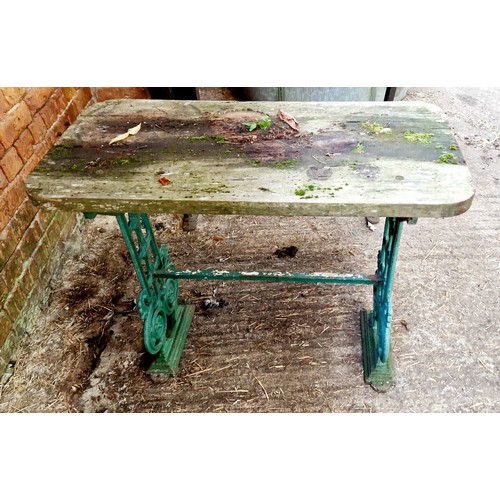 392 - Wooden garden table on ornate cast iron base