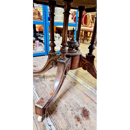 278 - Victorian walnut oval tilt-top tea table with boxwood inlay, four fluted supports to an ornate base ... 