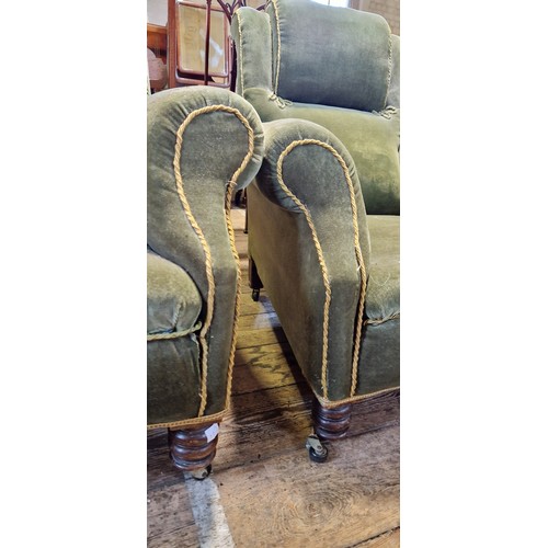 281 - A pair of Victorian deep seated fireside armchairs upholstered in green velvet