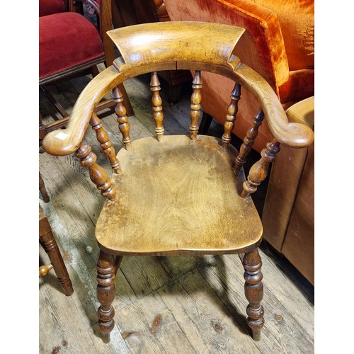 293 - A Victorian elm spindle back armchair with scrolling arms and turned supports