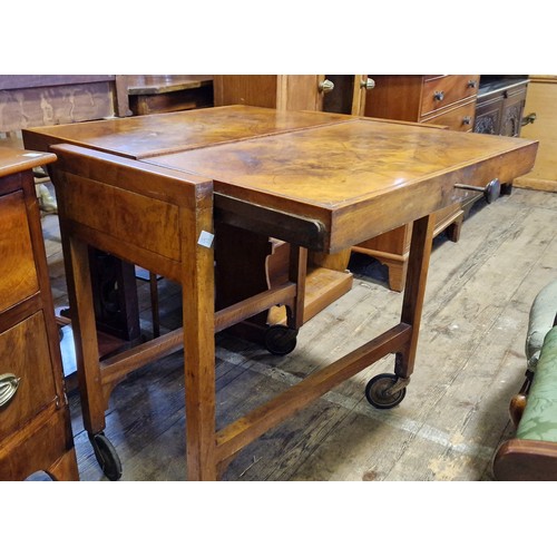 297 - Early 20th century walnut metamorphic 2-tier tea trolley which converts to a table