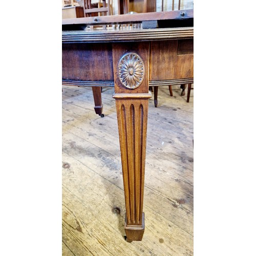 305 - An early 20th century oval mahogany extending dining table on fluted and square legs to brass castor... 