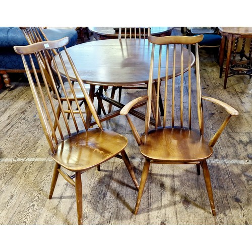 307 - Ercol circular drop leaf dining table and 4 spindle back chairs, one carver