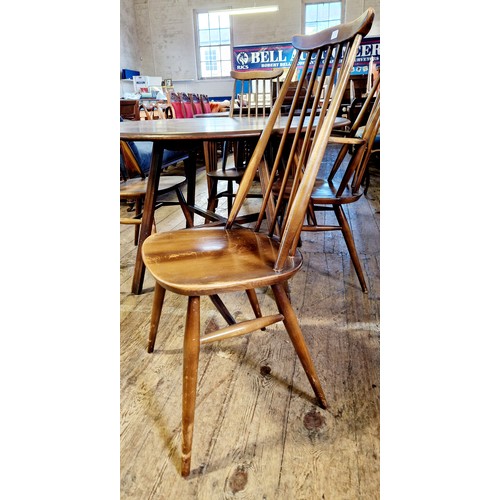 307 - Ercol circular drop leaf dining table and 4 spindle back chairs, one carver