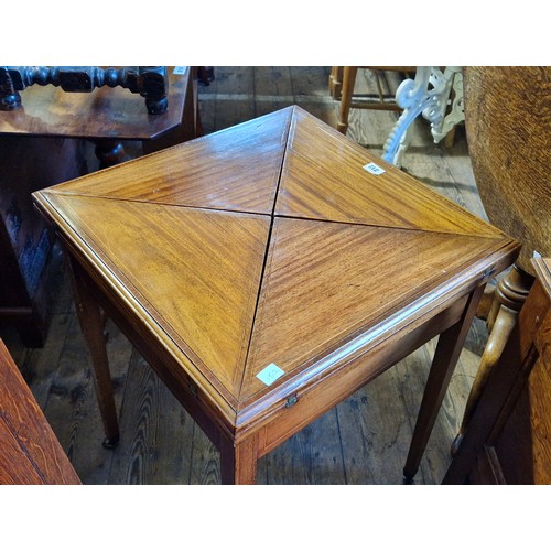 312 - A Victorian envelope card table with boxwood stringing and drawer on tapering square legs to castors