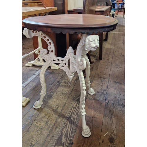 320 - Cast metal pub table with lions mask on paw feet and circular wooden top