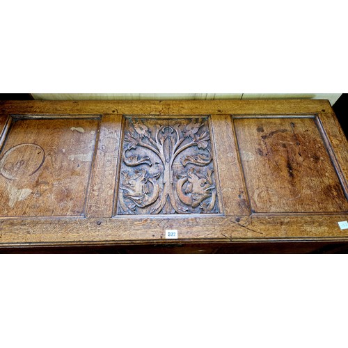 322 - Oak 3 panelled coffer with candle box and relief carving to the lid on raised legs