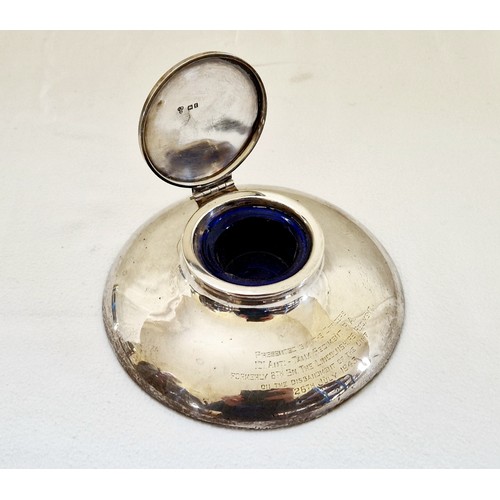 233 - A large London 1921 silver capstan inkwell, with blue glass liner and presentation inscription for t... 