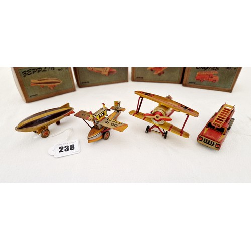 238 - A collection of four ZZ tin plate toys; Seaplane No 7; Aeroplane No 5; Fire engine No 9 and Zepplin ... 